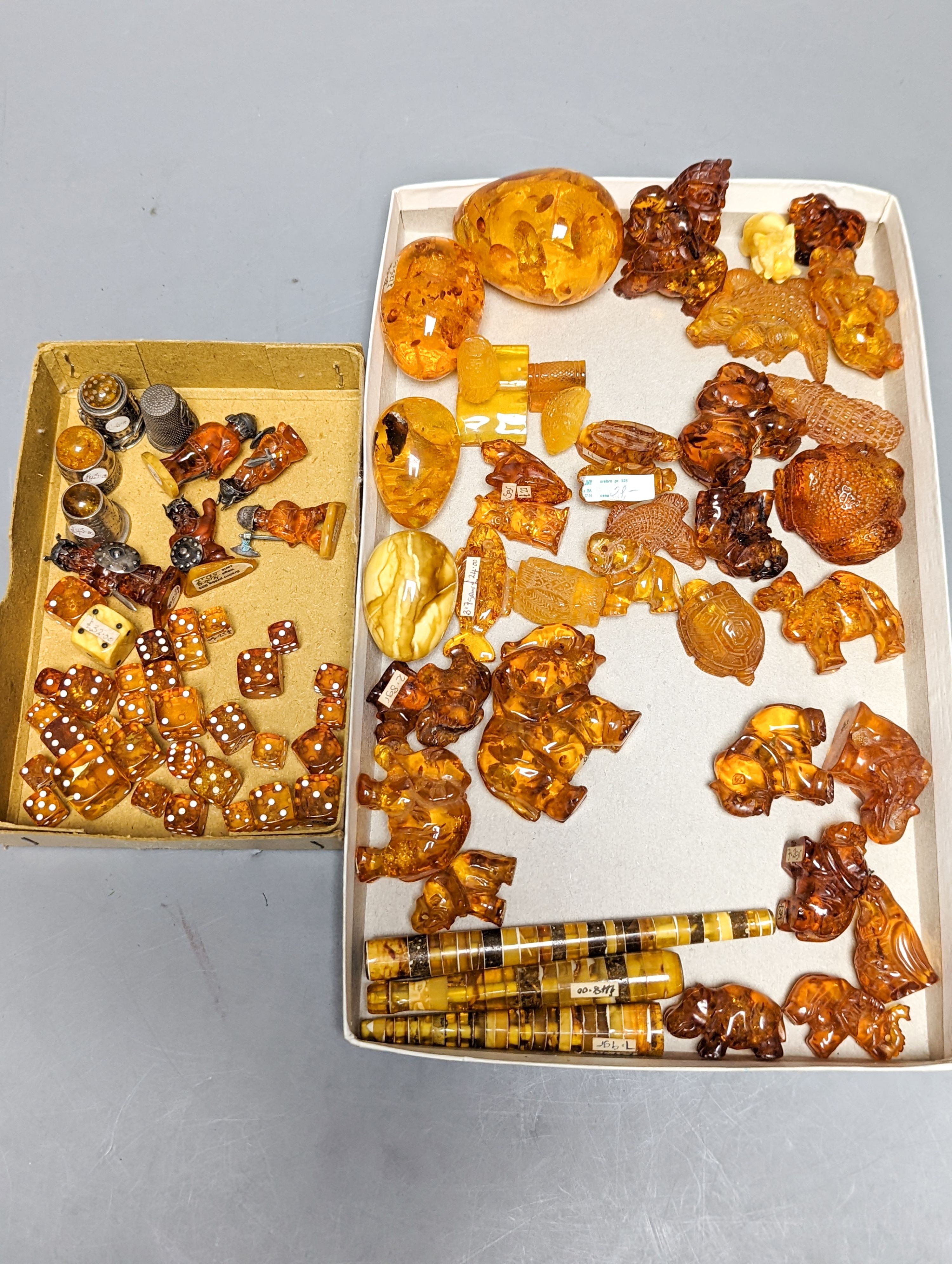 A mixed collection small carved amber wares including dice, eggs and cigarette holders, etc.